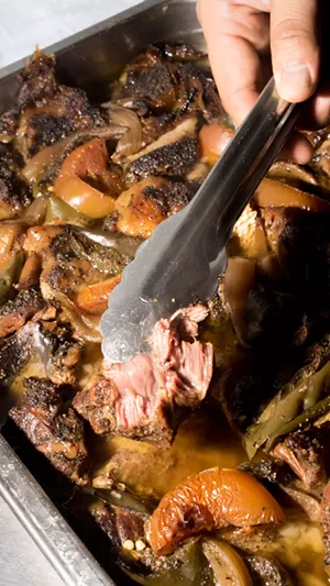 A chunk of beef cheek gets pulled from the roasted veggies and rendered fat that it's been smoked in for 16 hours. - SHELBY MOORE