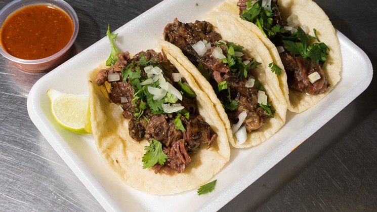 Armando Hernandez recommends the red salsa to accomodate the barbacoa tacos. - SHELBY MOORE