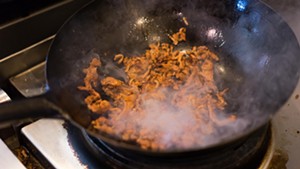 The wok quickly caramelizes the strips of meat from end to end. - SHELBY MOORE