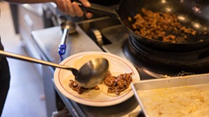 The al pastor is dished onto tortillas. - SHELBY MOORE