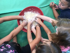 Students mixing dough. - COURTESY OF LAUREN SARIA