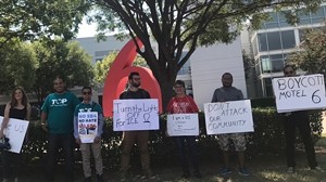 Around 12 activists gathered outside of G6 Hospitality corporate headquarters in Carrollton, Texas on Friday. - SALVADOR G. SARMIENTO