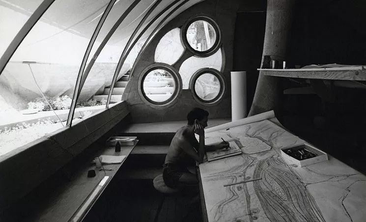 Stuart A. Weiner, Soleri sketching at his desk, Cosanti, ca. 1960. Gelatin-silver print, 10 x 8 inches. Collection of the Costanti Foundation. Copyright: The Weiner Estate. - COURTESY OF SCOTTSDALE MUSEUM OF CONTEMPORARY ART