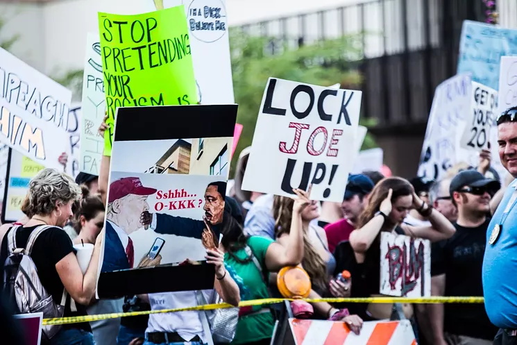 Protesters made it clear they weren't in favor of a pardon for Joe Arpaio during President Trump's visit to Phoenix. - ZEE PERALTA