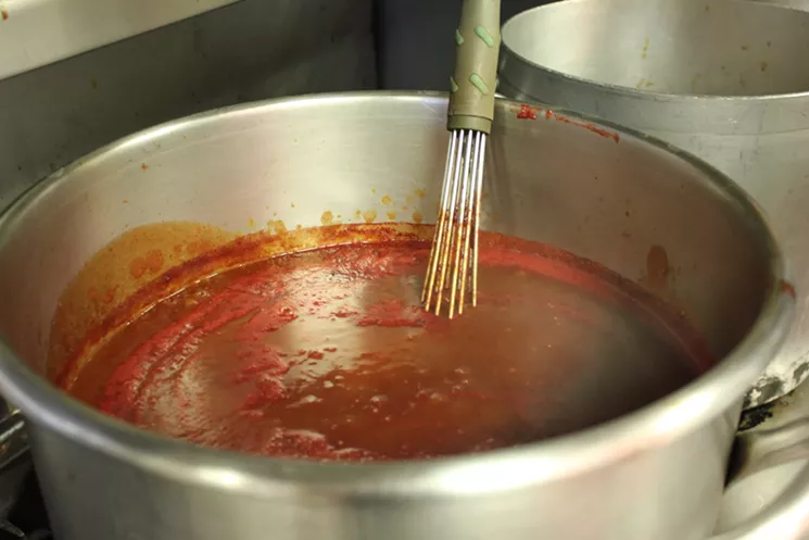 Dooley's tomato-based barbecue sauce brings a nice tang that cuts the fat of smoked meat. - CHRIS MALLOY