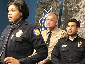 Phoenix Police Chief Jeri Williams tells reporters about an I-10 gun battle involving a fleeing murder suspect this week, as DPS Director Col. Frank Milstead (center) watches, on November 29, 2017. - SEAN HOLSTEGE