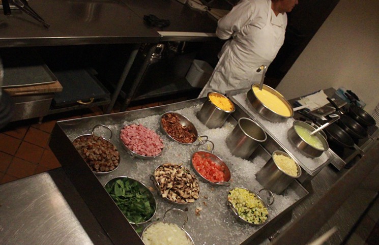 Omelet bar chef awaiting the next custom order at the Mission Grille at Tempe Mission Palms. - KAT SIMONOVIC