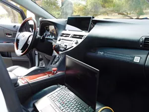 Waymo Lexus interior. The big red button stops the vehicle's autonomous function — but could the operator switch to manual mode fast enough if necessary at 65 mph? - RAY STERN