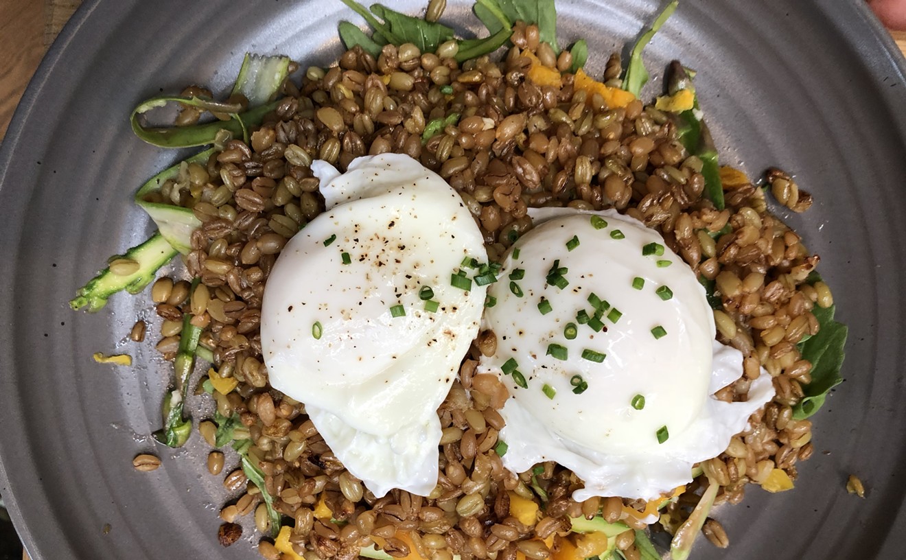 A plate of poached eggs, grains, squash, asparagus, and more.