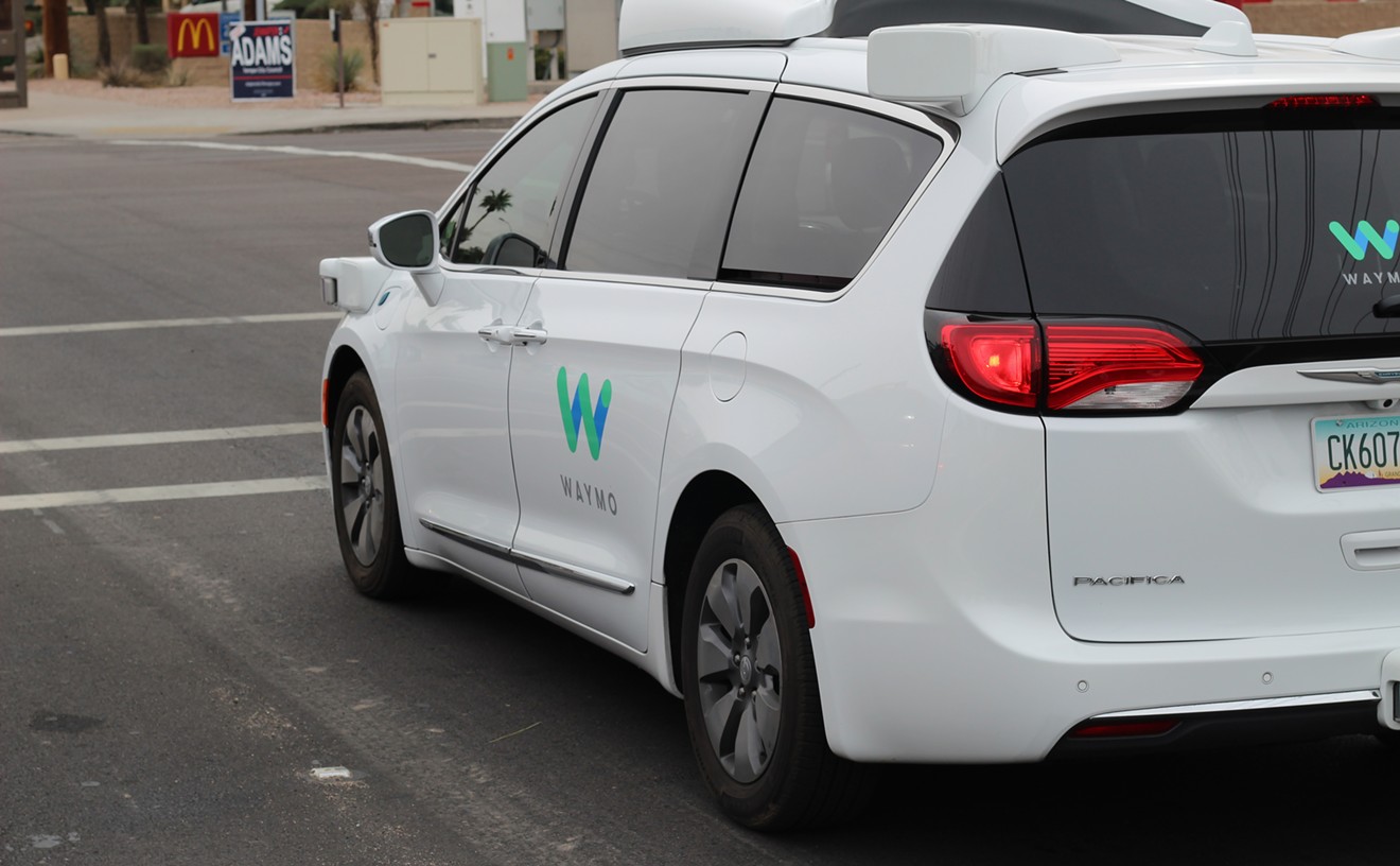 A Waymo Chrysler Pacifica autonomous vehicle, with backup driver, roaming the streets of Tempe.