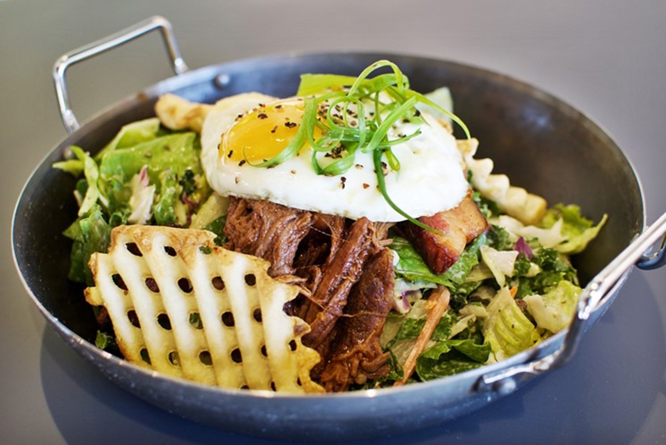 Decadence and virtue combine in the Ultimate Stak from GRUBSTAK: waffle fries, greens, pork belly, barbecue beef, and a fried egg.