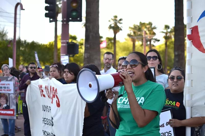 About 25 protesters stationed themselves at the entrance to the Phoenix Art Museum on Thursday evening to protest Arizona Public Service and its CEO, Don Brandt.