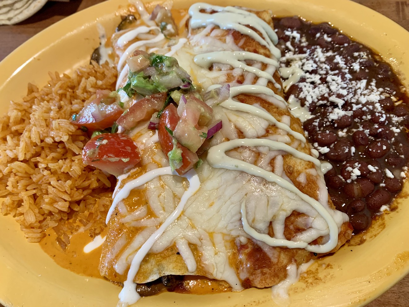 Enchiladas filled with beef birria and wild mushrooms at Cocina Madrigal.