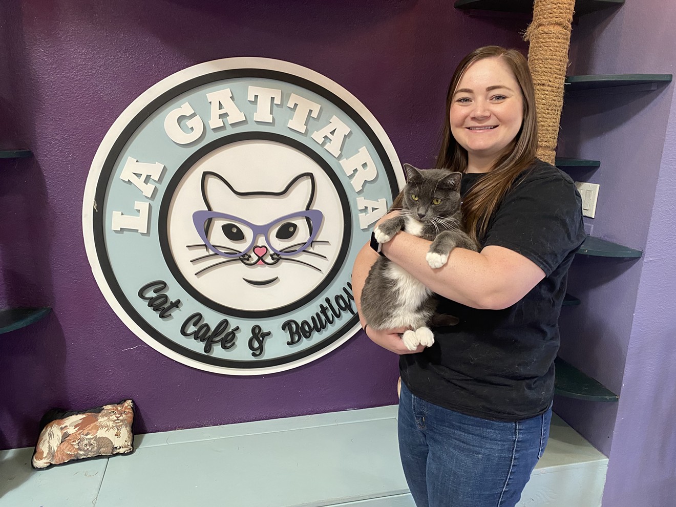 La Gattara Cat Cafe's owner, Carrie Pawpins, holds Flavio, one of the adoptable cats living at the rescue.
