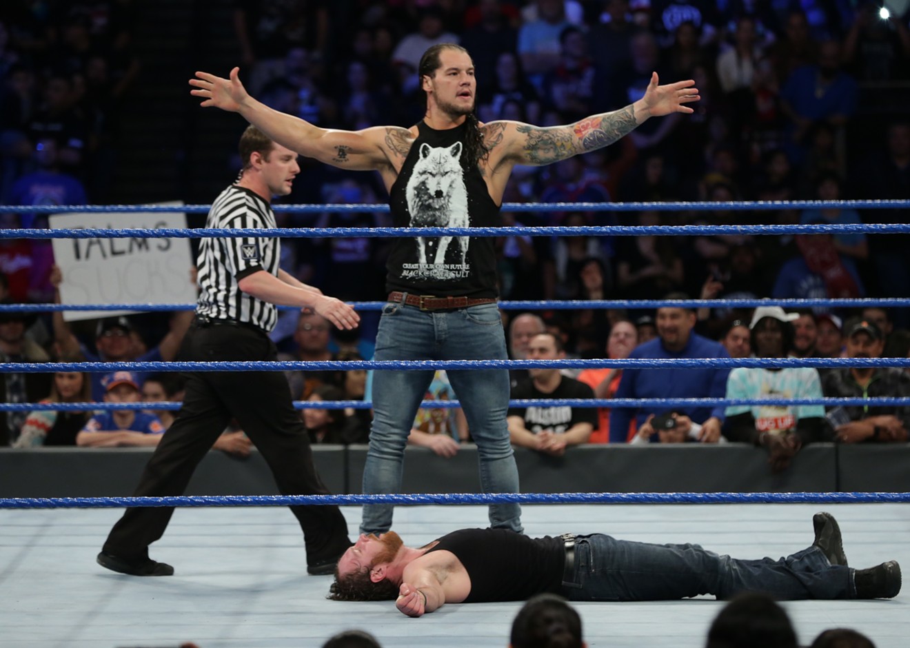 WWE superstar Baron Corbin stands tall over Dean Ambrose during a recent match.