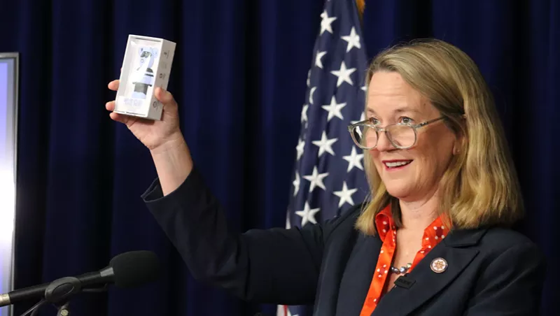 Image: kris mayes holds up a vape cartridge at a press conference