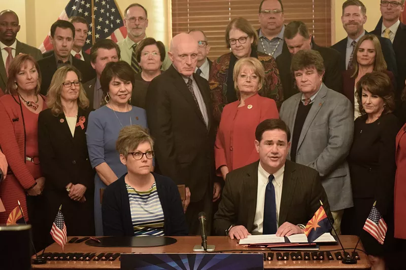 Image: Governor Doug Ducey, flanked by lawmakers and other water stakeholders, signs legislation authorizing Arizona to approve the Drought Contingency Plan on January 31.