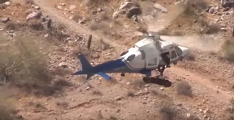 Image: A woman in a stretcher spins out of control during a helicopter rescue at Piestewa Peak on Tuesday morning.
