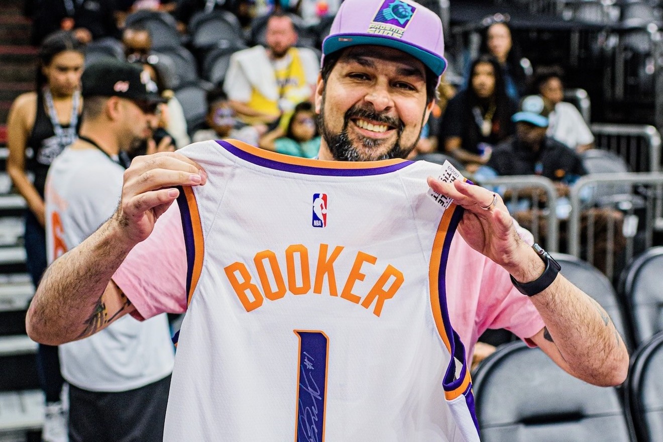 Henry Garcia with an autographed Devin Booker jersey he picked up at a Nov. 10 event at Footprint Center.
