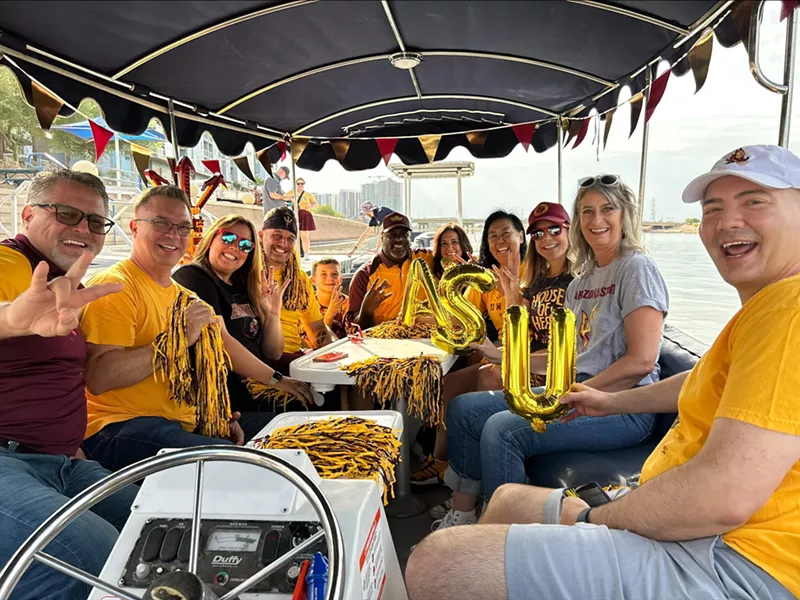 Image: Arizona State football fans now have the option to take a boat to ASU home games. This trip included fan Tim Gomez, fourth from the left, and Sue Rigler, third from the right, the owner of Hundred Mile Brewing who came up with the idea.
