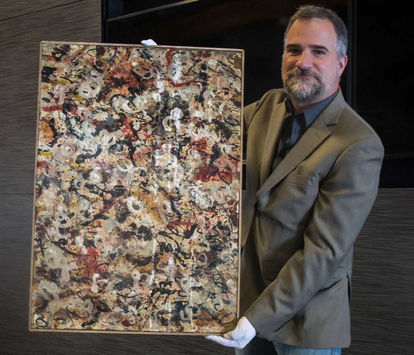 Josh Levine, owner and CEO of J. Levine Auction & Appraisal, with a painting he attributes to Jackson Pollock.