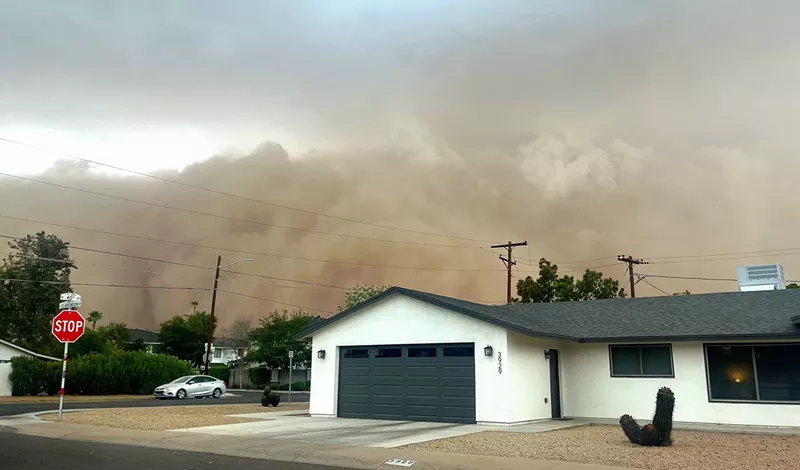Image: a haboob billows behind a white house