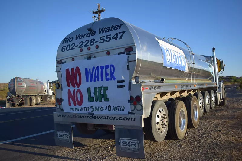 Image: Water-hauling company trucks parked outside of a community forum in Desert Hills on October 8. The trucks are scheduled to lose access to Phoenix fire hydrants by the end of the year.