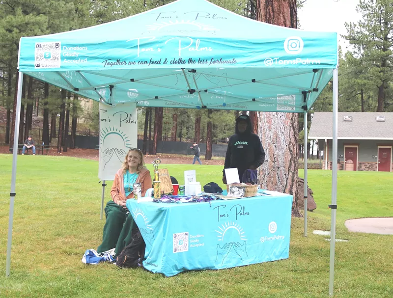 Image: Tammy Broselaw (left) and her husband set up at the Beat Therapy 2k concert in late July.