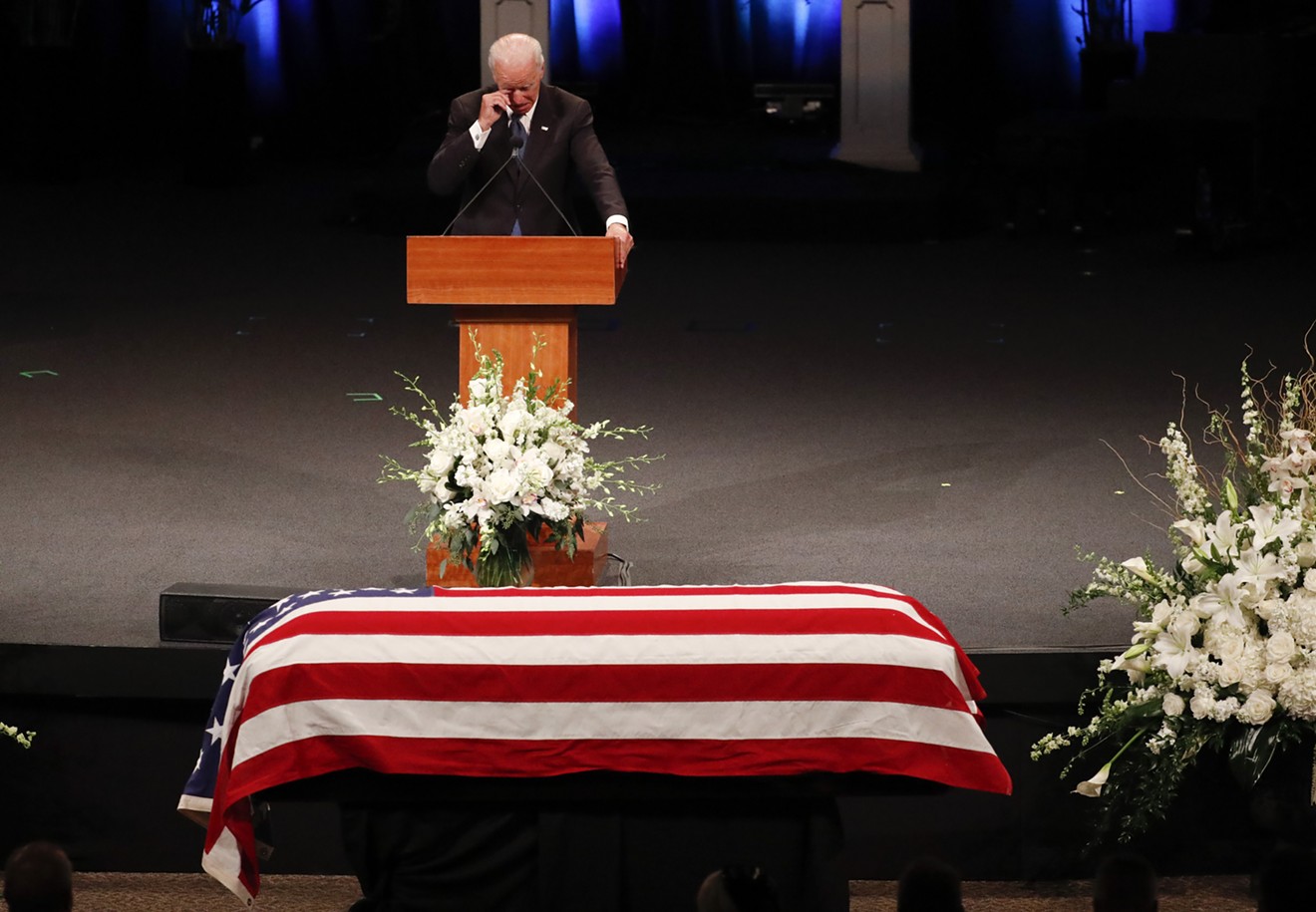 Former Vice President Joe Biden wipes away a tear as he eulogizes his friend John McCain in Phoenix.
