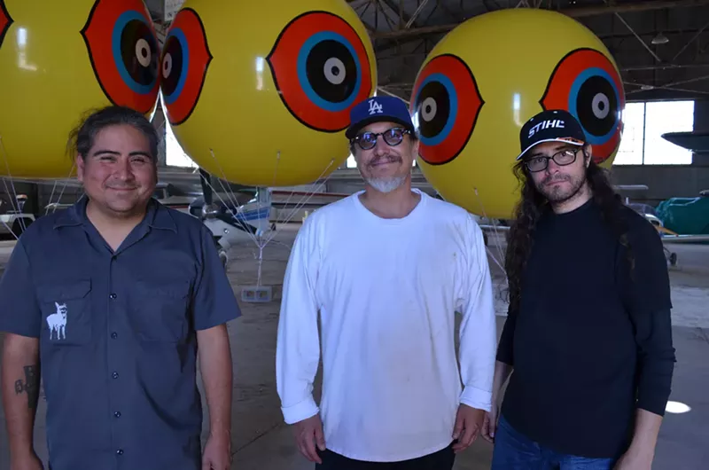 Image: Postcommodity artists (from left) Raven Chacon, Kade L. Twist, and Cristóbal Martínez while preparing to install Repellent Fence.