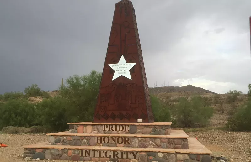 Image: A marker at the entrance to the Arizona Law Enforcement Academy in Phoenix. The inter-governmental agreement which funded the academy ended last month.