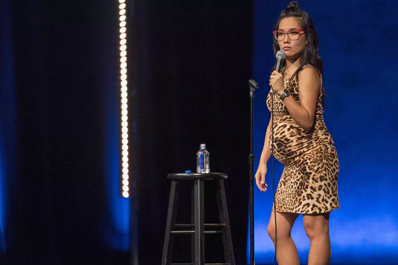 Image: In Hard Knock Wife, her second Netflix special, Ali Wong wears a skintight, animal-print dress stretched over her baby bump that silently explodes the borders between maternal and sexy, feminine and funny, selfless and attention-seeking.