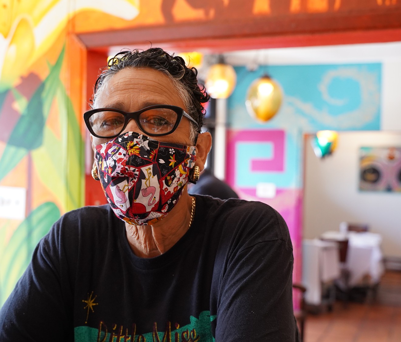 Chef Silvana Salcido Esparza surrounded by art inside Barrio Cafe.