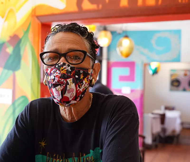 Image: Chef Silvana Salcido Esparza surrounded by art inside Barrio Cafe.
