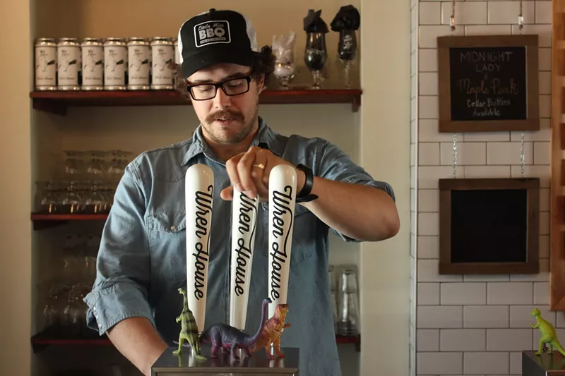 Image: Preston Thoeny, head brewer at Wren House Brewing Company, takes a break from brewing to pour a draft.