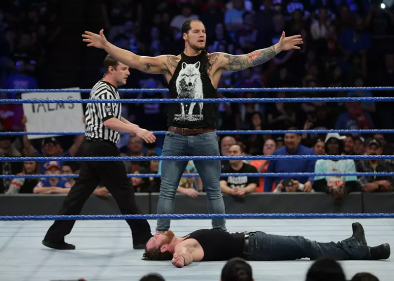 Image: WWE superstar Baron Corbin stands tall over Dean Ambrose during a recent match.