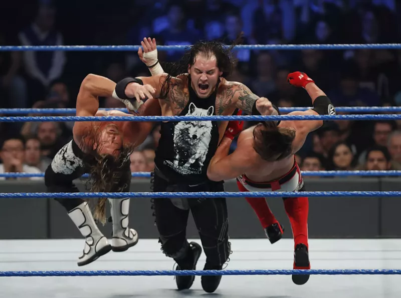 Image: Baron Corbin clotheslines Dolph Ziggler and AJ Styles on an episode of SmackDown Live.