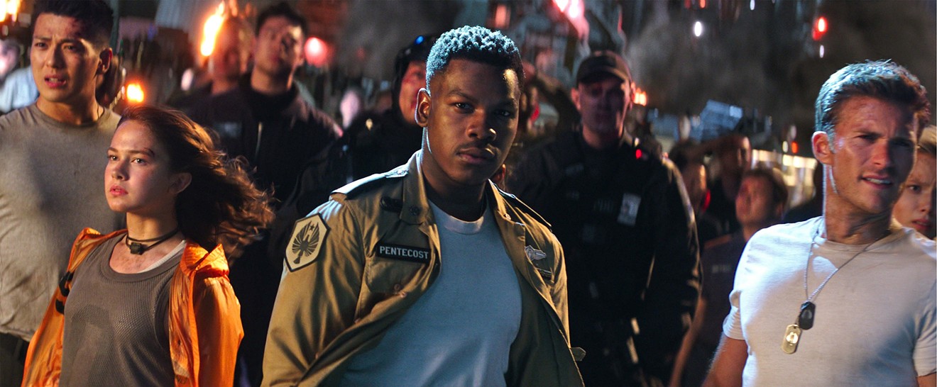 The cast of Pacific Rim Uprising includes (from left): Cailee Spaeny as Amara, John Boyega as Jake, and Scott Eastwood as Nate.