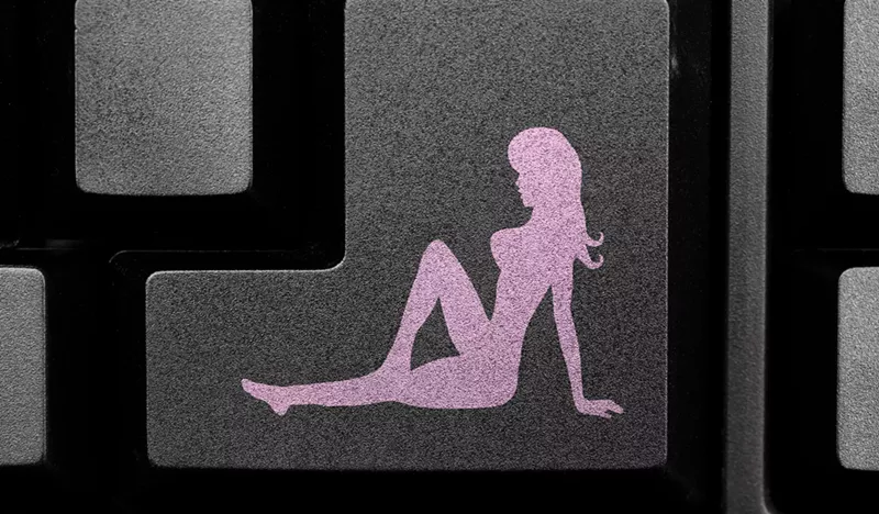 Image: a silhouette of a naked woman on a computer keyboard