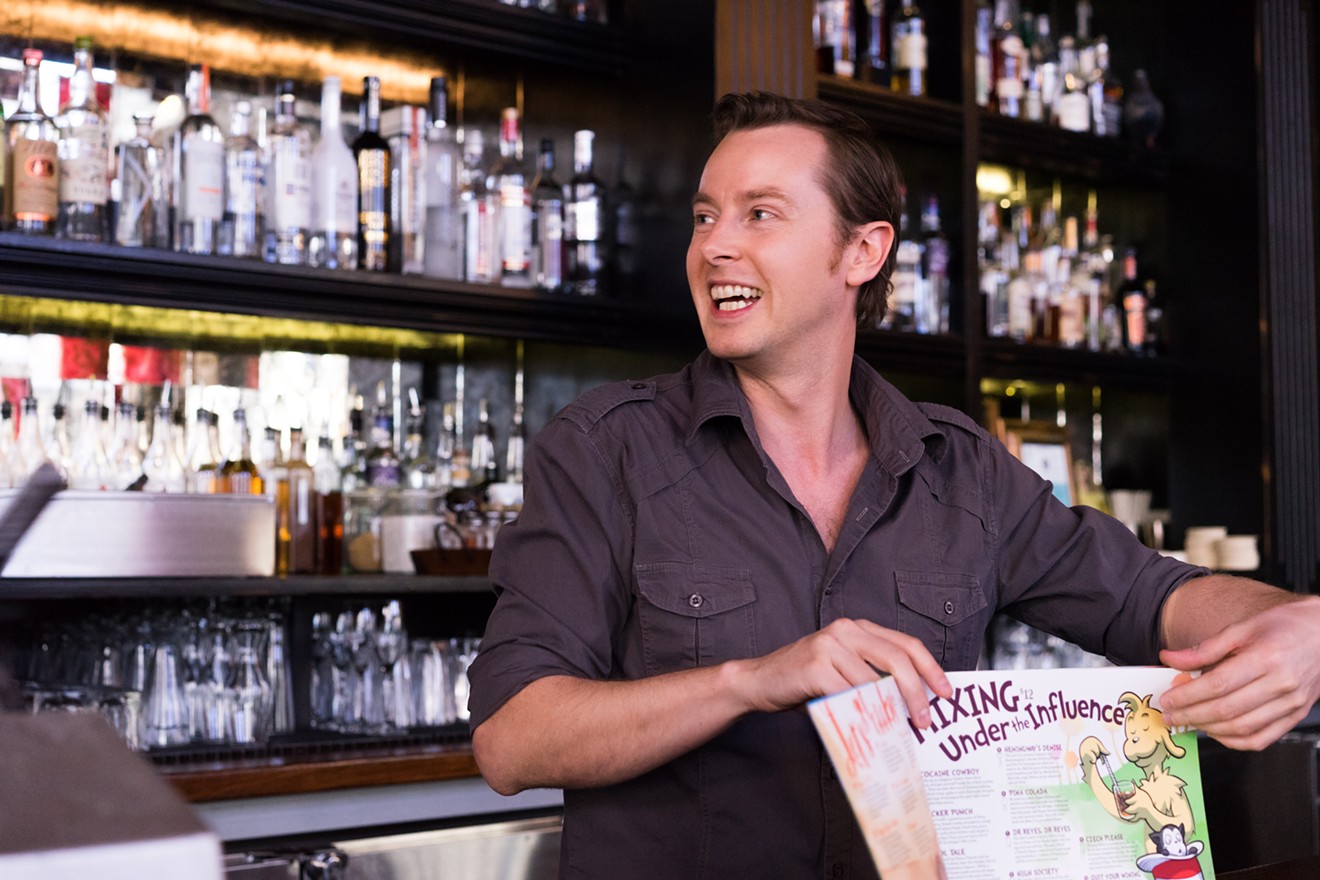 Bitter & Twisted proprietor Ross Simon shows off the bar 's latest menu, debuting tonight. It's their most expensive to create thus far, Simon says.