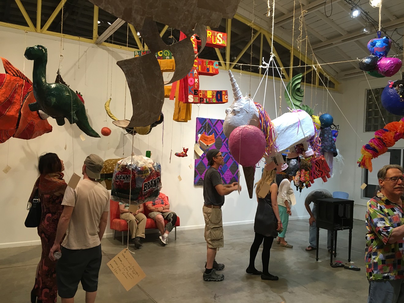 Visitors hanging around with art during the Mutant Piñata Show in 2016.